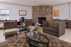 a living room with a couch and a fireplace at Old Mill Inn in Omaha