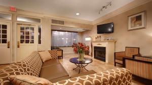 a living room with a couch and a fireplace at Best Western Watertown/Fort Drum in Watertown