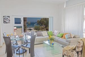 a living room with a couch and a table at Pallini Court in Protaras