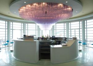 a large chandelier in a large room with a bar at The Midland in Morecambe
