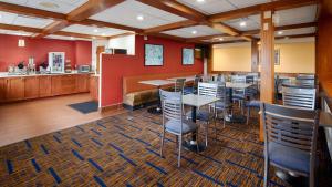 a dining room with tables and chairs on a rug at Best Western Benton Harbor – St. Joseph in Benton Harbor