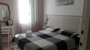 a bed with a white comforter and pillows on it at Su per i Coppi in Manarola