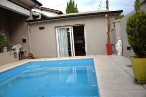 a swimming pool in front of a house at Loft Urbano in Tandil