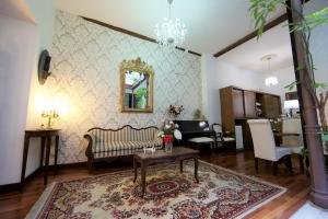 a living room with a couch and a table at Hotel Boutique Nueve Leyendas in Úbeda