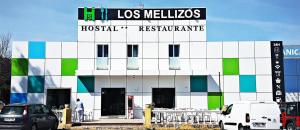 a building with a sign on top of it at Hostal Restaurante Los Mellizos in Guarromán