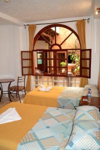 Postel nebo postele na pokoji v ubytování Hotel Villa Florencia Centro Histórico