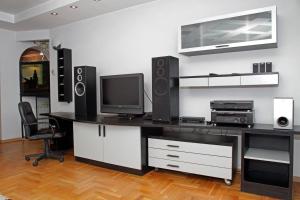 a room with a desk with a tv and speakers at Belgrade Republic Square Apartment in Belgrade
