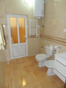 a bathroom with a toilet and a sink and a door at Guest House Jelena in Budva +67 photos