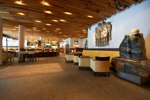 a restaurant with a couch and tables and chairs at Hotel Liebe Sonne in Sölden