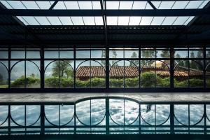 a large glass building with a view of the water at Cuesta Serena Boutique Hotel in Huaraz
