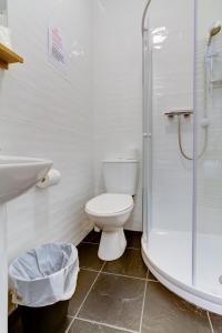 a white bathroom with a toilet and a shower at New Brooklyn in Blackpool
