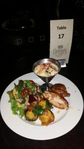 a plate of food on a table with a plate of food at Cattleman's Rest Motor Inn in Charters Towers