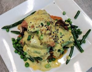 a white plate of food with peas and meat at Cattleman's Rest Motor Inn in Charters Towers