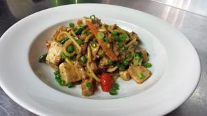 a white plate of food with noodles and vegetables at Cattleman's Rest Motor Inn in Charters Towers