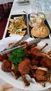a table with a plate of food on it at Cattleman's Rest Motor Inn in Charters Towers