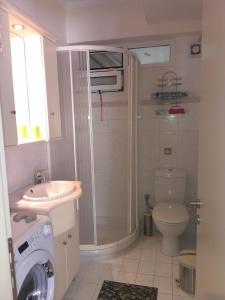 a bathroom with a shower and a toilet and a sink at Patra - Cute studio near center in Patra