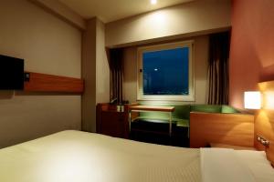 Postel nebo postele na pokoji v ubytování Candeo Hotels Sano