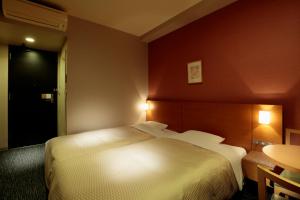 Postel nebo postele na pokoji v ubytování Candeo Hotels Sano