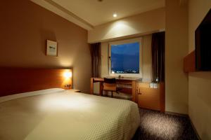Łóżko lub łóżka w pokoju w obiekcie Candeo Hotels Sano