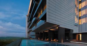 an external view of a building with a swimming pool at Trident Hyderabad in Hyderabad