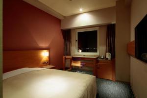 Postel nebo postele na pokoji v ubytování Candeo Hotels Sano
