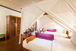 Postel nebo postele na pokoji v ubytování Junjungan Ubud Hotel and Spa + 37 fotografií