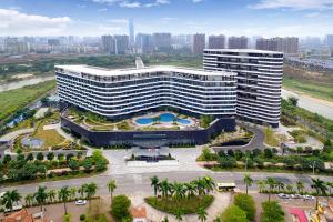 an aerial view of a large building with a pool at Grand Skylight International Hotel Huizhou in Huizhou