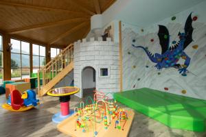 a play room with a rock climbing wall at Alpenhotel Neuwirt in Schladming