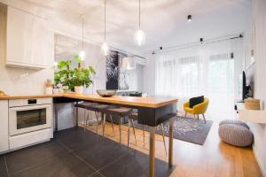 a kitchen with a large wooden table and chairs at Hella Apartment in Zagreb