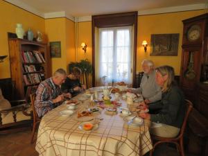 a group of people sitting around a table eating food at La Datiniere in Parigny