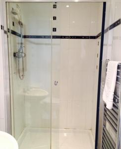 a bathroom with a glass shower with a sink at The Crown Hotel in Peebles
