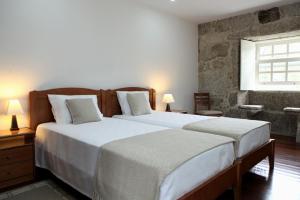 a bedroom with two beds and a window at Recantos na Portela in Amares +37 photos