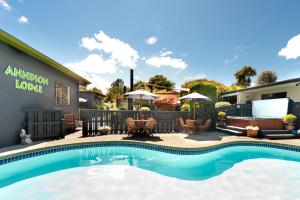 a swimming pool in front of a building with a restaurant at Anndion Lodge Motel & Conference Centre in Whanganui