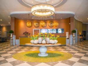 a lobby with a table with vases of flowers at Midlands Park Hotel in Portlaoise