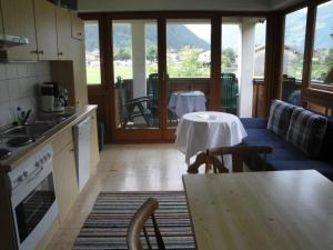a kitchen with a table and a dining room with a table at Gästehaus Brindlinger in Zell am Ziller