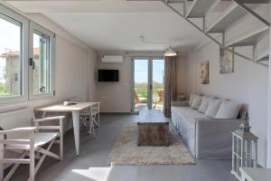 a living room with a couch and a table at Alati Apartments in Paralía Sergoúlas