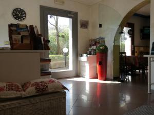 a living room with a large window and a table at Hotel La Passeggiata in Desenzano del Garda