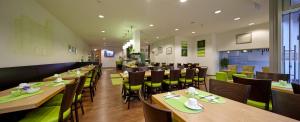 a dining room with wooden tables and chairs at ante porta DAS STADTHOTEL in Trier