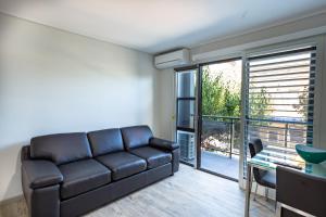 a living room with a couch and a table at Hamilton on Beaumont in Newcastle