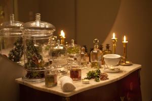 a table with many glass jars and candles on it at Carmo's Boutique Hotel - Small Luxury Hotels of the World in Ponte de Lima