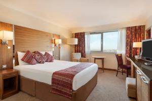 a hotel room with a large bed and a television at Waterfront Southport Hotel in Southport