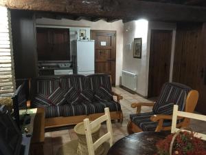 a living room with two couches and a refrigerator at El Pajar del Castillo in Mora de Rubielos