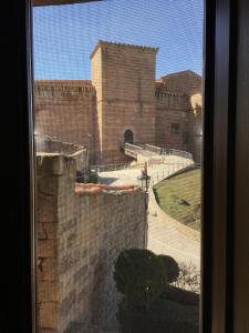 a view of a building from a window at El Pajar del Castillo in Mora de Rubielos