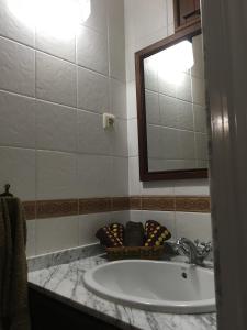 a bathroom with a sink and a mirror at El Pajar del Castillo in Mora de Rubielos