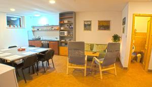 a kitchen and dining room with a table and chairs at Ubytovanie Ahoj v prírode in Mýto pod Ďumbierom