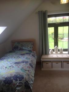 a bedroom with a bed and a window at Ty Erin in Llandeilo