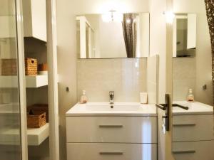 a bathroom with a sink and a mirror at La Rade in Cassis