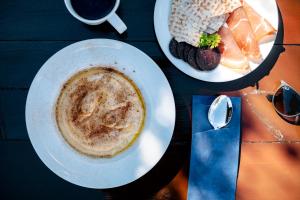 a table with two plates of food and a cup of coffee at Fagernes Camping in Fagernes