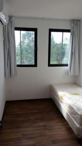 a white room with two windows and a bed at Mocaccino in El Pinar