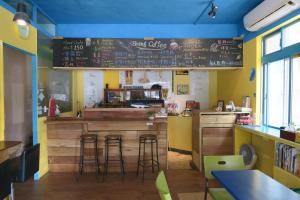 a restaurant with a bar with a chalkboard on the wall at Being Outdoor in Gongliao